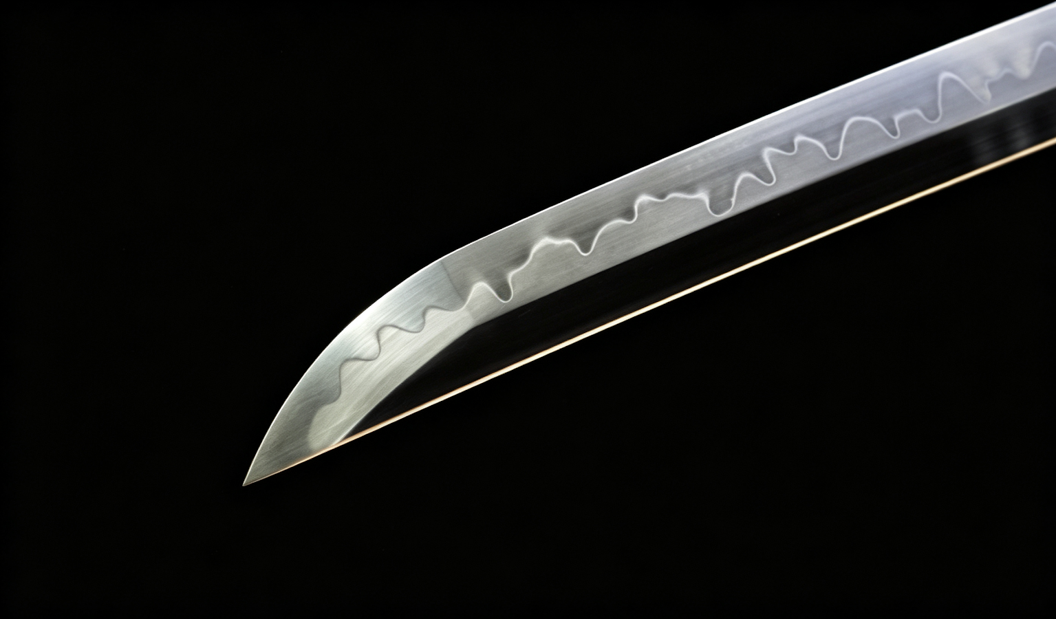 Close view of a wavy hamon on a polished 1095 blade